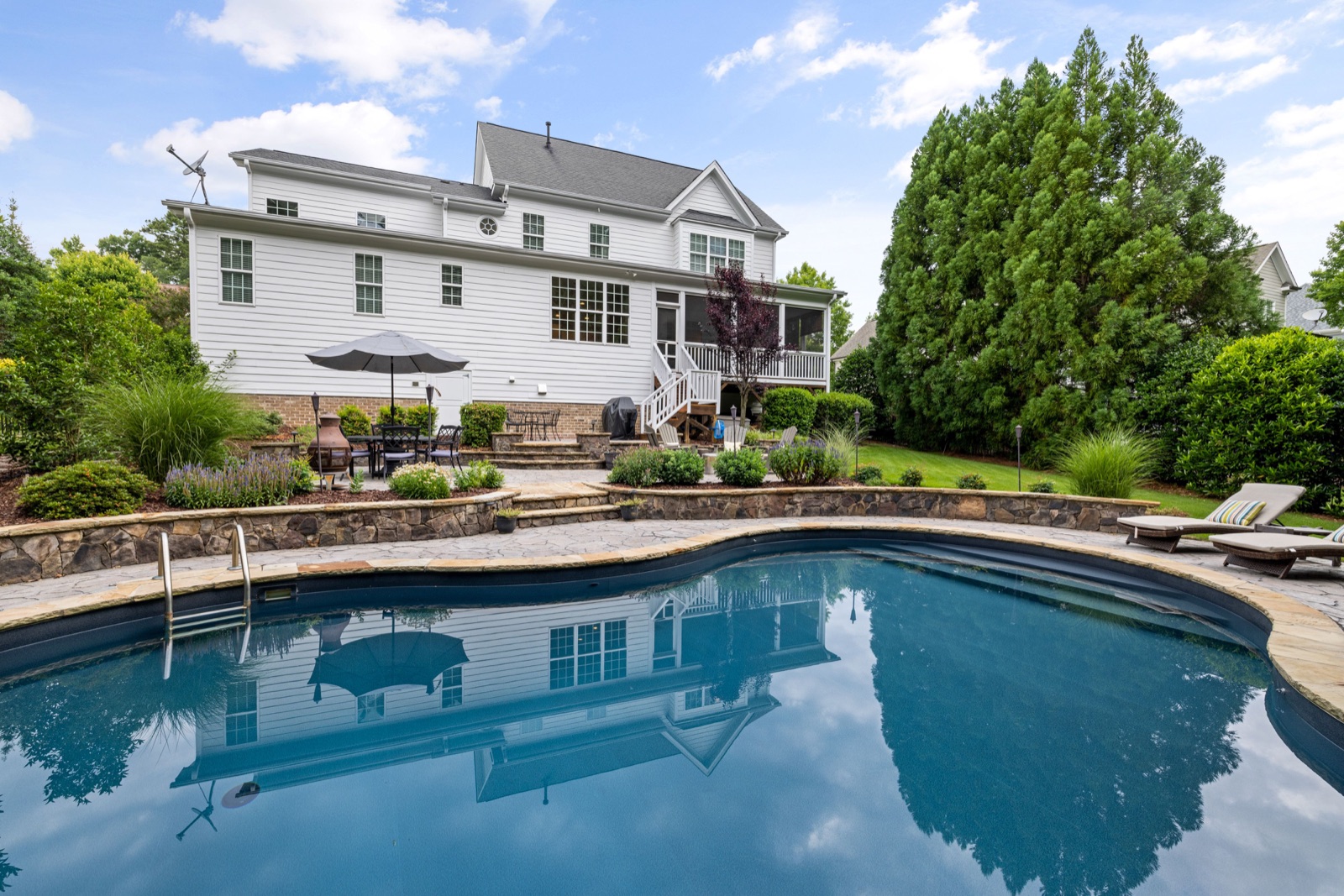 Backyard pool with stone patio