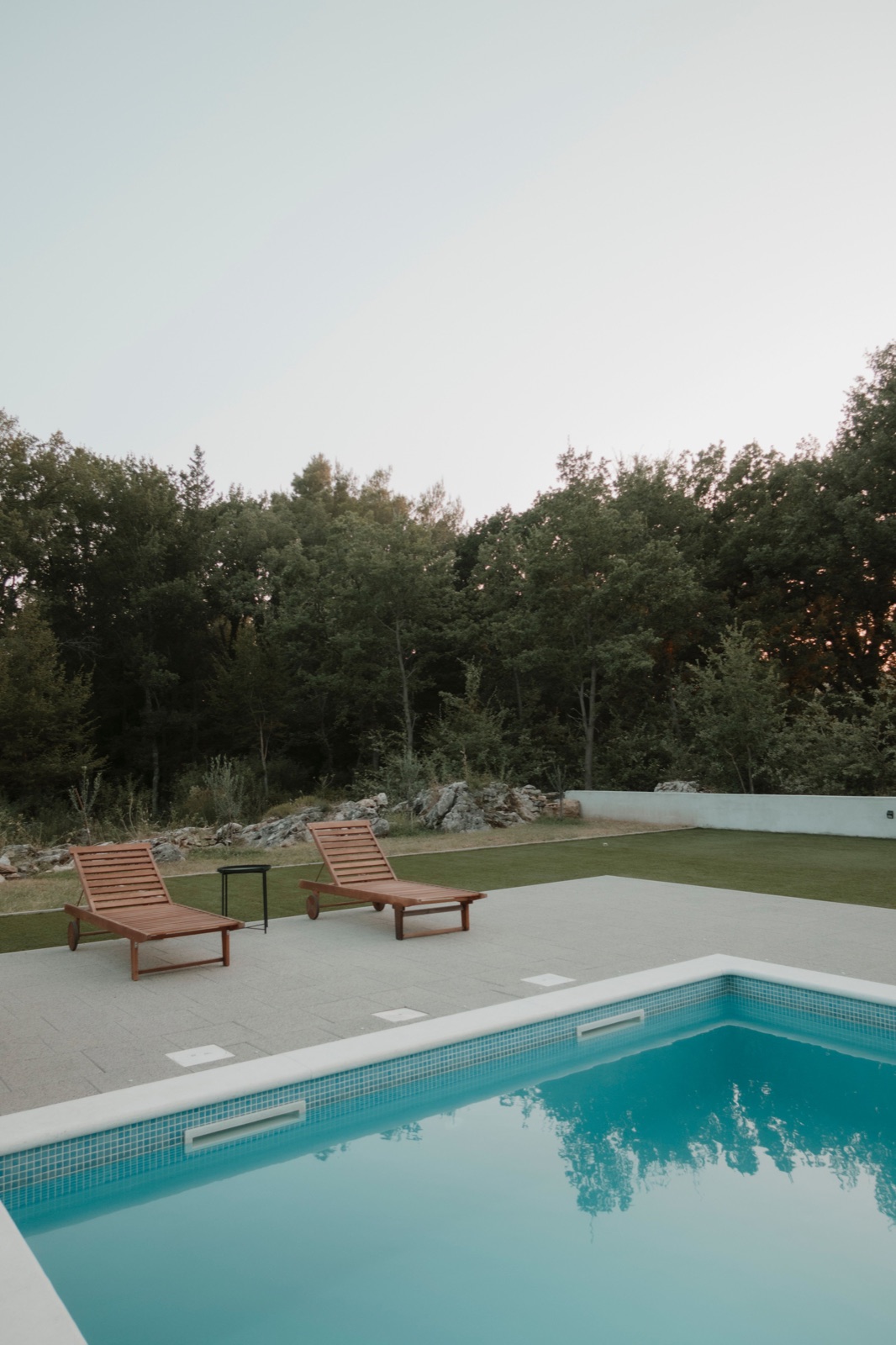 Pool at dusk with loungers